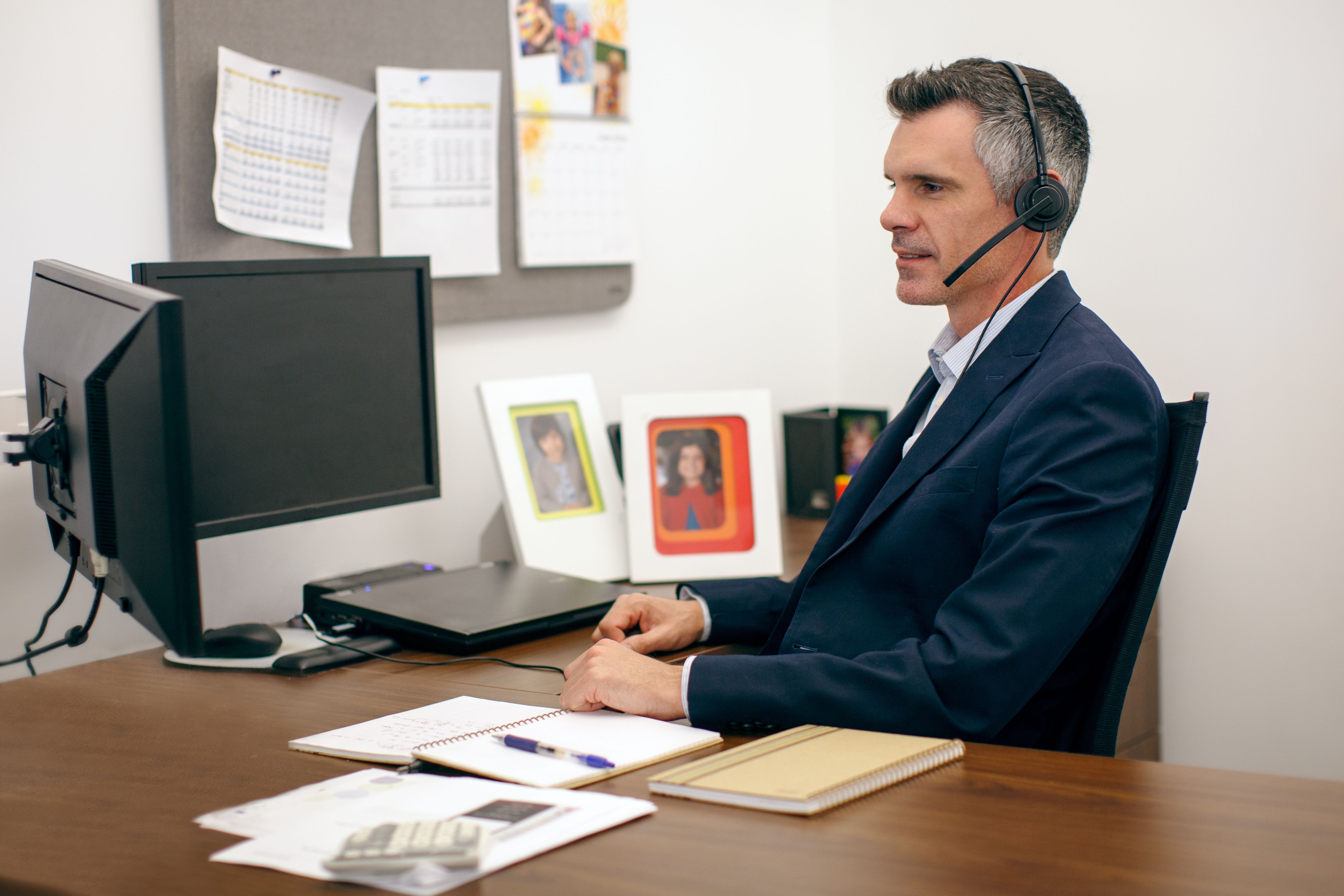 Lawyer working at desk with Headaset on